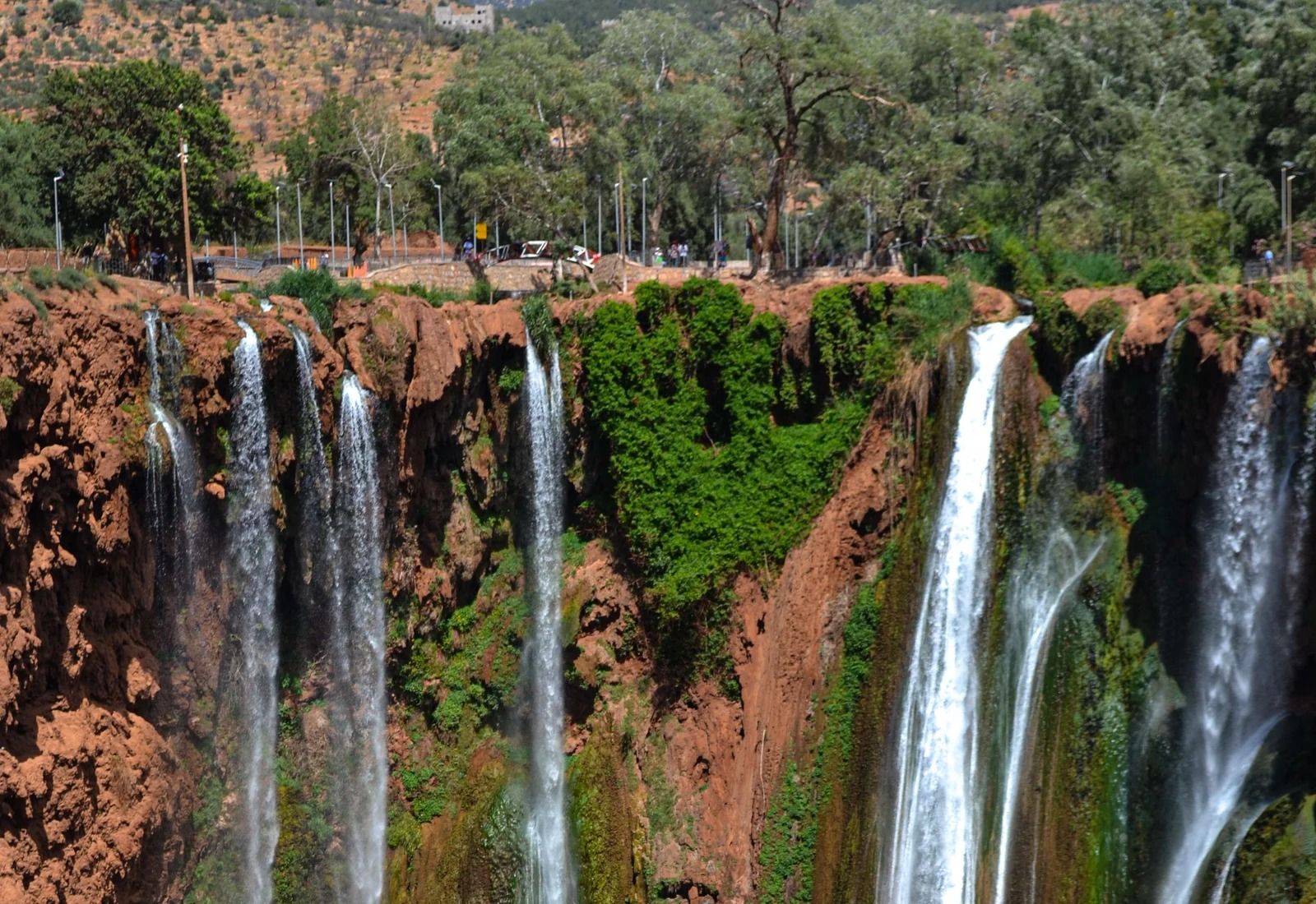 The upper Ouzoud falls dropping in many streams below the olive trees of the plateau